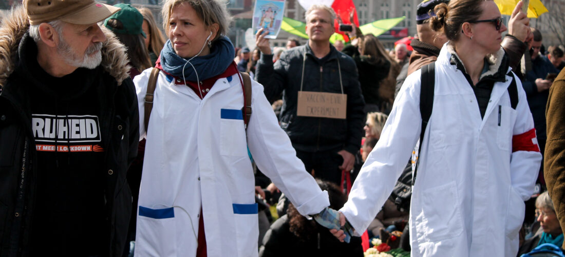 Achter een rij mannen, gekleed als veteranen, staat een rij gekleed als zorgpersoneel. Het is niet bevestigd dat dit echte veteranen zijn of zorgpersoneel is.