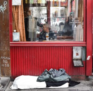 A abandound matress, in front of a populair café.