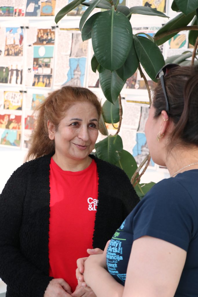 Two women speaking.