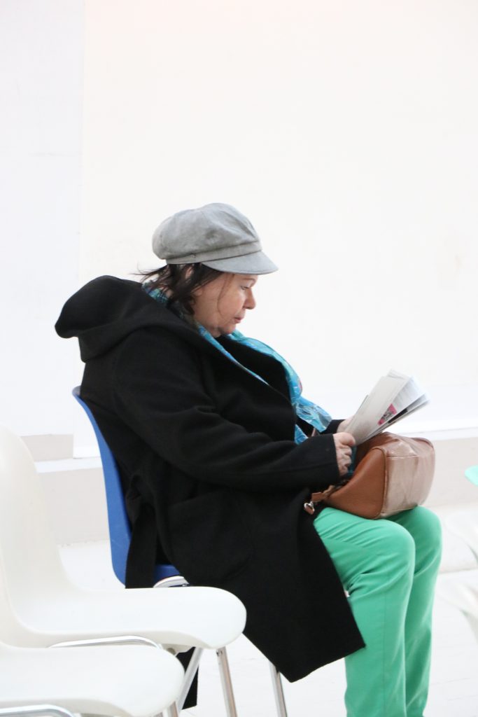 A woman reading a magazine.