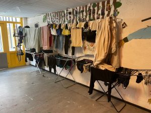 The residents' laundry hung up in an old classroom.