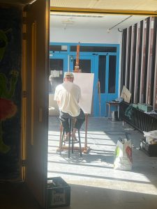 Thomas painting in one of the studios in an old classroom.