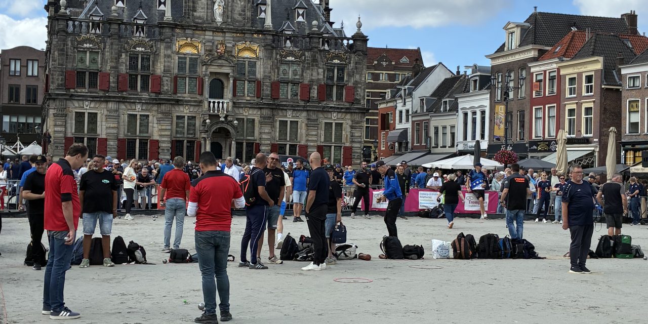 Oud tegen jong: petanque op het zand van de Markt in Delft.